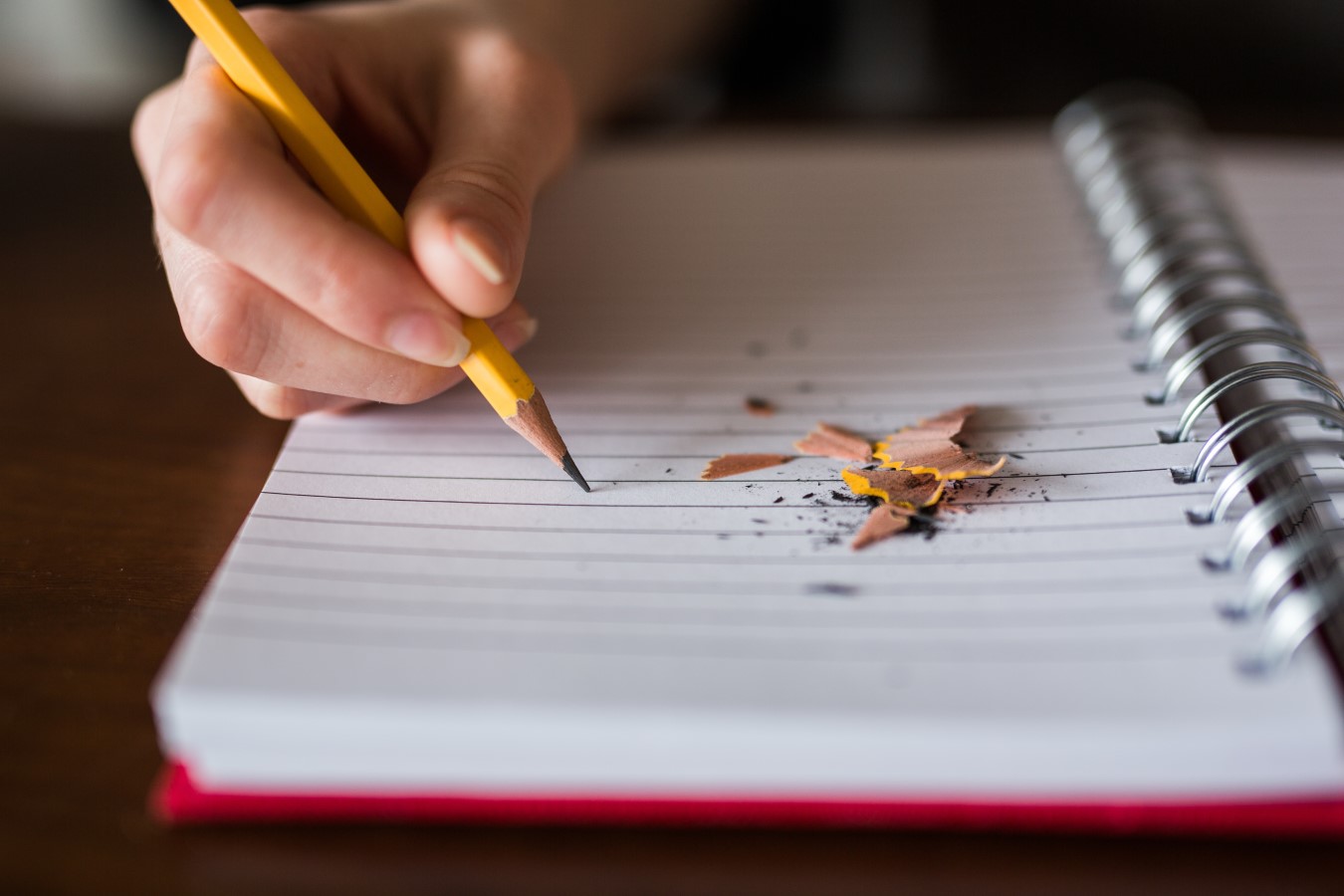 student writing in notebook